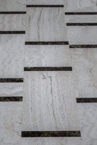 white travertine and emperador dark flooring
